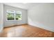 Bedroom with hardwood floors and natural light from a large window at 5126 Unaka Ave, Charlotte, NC 28205