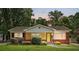 Charming single-story home with brick and stone facade, manicured lawn, and a welcoming yellow front door at 5126 Unaka Ave, Charlotte, NC 28205