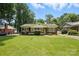 Well-maintained single-story home with a spacious front yard, mature trees, and inviting curb appeal at 5126 Unaka Ave, Charlotte, NC 28205