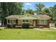 Charming single-story home featuring a manicured lawn, brick accents, and a classic design at 5126 Unaka Ave, Charlotte, NC 28205