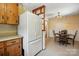 Kitchen features wooden cabinets and an eat-in dining area adjacent to a large refrigerator at 5126 Unaka Ave, Charlotte, NC 28205