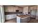 Modern kitchen with stainless steel appliances, gray cabinets, and island at 638 Amberjack Pl # 76, York, SC 29745