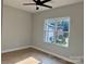 Bright bedroom with a ceiling fan and a window overlooking the yard and surrounding area at 908 30Th Avenue Nw Dr # 2, Hickory, NC 28601