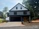 Charming two-story home with a black garage door, wood front door, gray siding, and modern design at 908 30Th Avenue Nw Dr # 2, Hickory, NC 28601