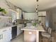 Modern kitchen with white cabinets, marble backsplash, large island, stainless steel appliances, and pendant lighting at 908 30Th Avenue Nw Dr # 2, Hickory, NC 28601