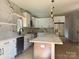 Modern kitchen with white cabinets, marble backsplash, large island, stainless steel appliances, and pendant lighting at 908 30Th Avenue Nw Dr # 2, Hickory, NC 28601