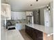 A modern kitchen featuring white cabinets, stainless steel appliances, and a spacious island with countertop seating at 908 30Th Avenue Nw Dr # 2, Hickory, NC 28601