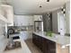 Modern kitchen with white cabinets, dark island, marble backsplash, stainless steel appliances, and pendant lighting at 908 30Th Avenue Nw Dr # 2, Hickory, NC 28601