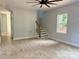 Bright open-concept living room featuring light grey walls, stairs, wood floors, and large window at 908 30Th Avenue Nw Dr # 2, Hickory, NC 28601