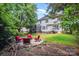 Spacious backyard with fire pit, seating area, and lush greenery, perfect for entertaining at 10230 Blackstock Rd, Huntersville, NC 28078
