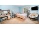 A comfortable bedroom showcases a cozy chair, desk, and soft lighting for a serene atmosphere at 10230 Blackstock Rd, Huntersville, NC 28078