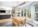 Bright dining area featuring large windows overlooking the backyard and an adjacent living room at 10230 Blackstock Rd, Huntersville, NC 28078