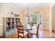 Bright dining room featuring a chandelier, hardwood floors, and bay windows for natural light at 10230 Blackstock Rd, Huntersville, NC 28078
