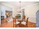 Traditional dining room featuring a glass table, four chairs, hardwood floors, and neutral walls at 10230 Blackstock Rd, Huntersville, NC 28078