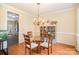 Charming dining room with hardwood floors, chandelier, and a modern shelf display at 10230 Blackstock Rd, Huntersville, NC 28078