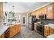 Kitchen area featuring wood cabinets, stainless steel appliances, and an open dining space at 10230 Blackstock Rd, Huntersville, NC 28078