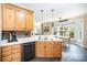 Spacious kitchen featuring wood cabinetry, stone backsplash, and an open view to dining area at 10230 Blackstock Rd, Huntersville, NC 28078
