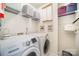 A functional laundry room featuring a washer, dryer, storage shelves, and ample space at 10230 Blackstock Rd, Huntersville, NC 28078