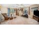 The light-filled bonus room boasts comfortable seating and an exercise area at 10230 Blackstock Rd, Huntersville, NC 28078