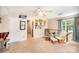 This living room boasts plenty of natural light, comfortable seating, and a ceiling fan at 10230 Blackstock Rd, Huntersville, NC 28078
