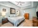 A well-lit main bedroom features a ceiling fan and two dressers, creating a cozy and functional space at 10230 Blackstock Rd, Huntersville, NC 28078