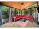 Relaxing sunroom features a ceiling fan, wood ceiling, and comfortable outdoor seating with tree views at 10230 Blackstock Rd, Huntersville, NC 28078