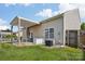 Spacious backyard featuring a patio with pergola and well-kept lawn at 10303 Dominion Village Dr, Charlotte, NC 28269
