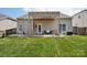 This backyard features a well-kept lawn and a patio with pergola, a perfect outdoor retreat at 10303 Dominion Village Dr, Charlotte, NC 28269