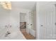 Bright bathroom with double sink vanity and tub with shower at 10303 Dominion Village Dr, Charlotte, NC 28269