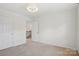 Neutral bedroom with carpet and adjacent room access to hallway at 10303 Dominion Village Dr, Charlotte, NC 28269