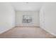 A bedroom with plush carpeting, a window, and neutral paint provides a serene space at 10303 Dominion Village Dr, Charlotte, NC 28269
