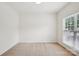 A vacant bedroom provides natural light with a neutral color palette, and carpeted floor at 10303 Dominion Village Dr, Charlotte, NC 28269