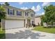 Charming two-story home featuring a two-car garage, landscaped yard, and inviting front porch at 10303 Dominion Village Dr, Charlotte, NC 28269