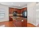 An open kitchen boasts granite counters, dark cabinetry, stainless appliances and central island with sink and faucet at 10303 Dominion Village Dr, Charlotte, NC 28269