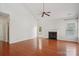 Bright and airy living room with hardwood floors, a fireplace, and plenty of natural light at 10303 Dominion Village Dr, Charlotte, NC 28269
