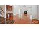 Open-concept living room featuring hardwood floors, a fireplace, and natural light at 10303 Dominion Village Dr, Charlotte, NC 28269