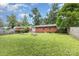 View of a backyard with a brick house in the background at 1033 Rollingwood Dr, Charlotte, NC 28217
