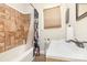 Cozy bathroom featuring a shower-tub combination and neutral tiling at 1033 Rollingwood Dr, Charlotte, NC 28217