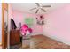 Bedroom with hardwood floors, pink walls, a window, and a ceiling fan at 1033 Rollingwood Dr, Charlotte, NC 28217