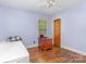 Bedroom with hardwood floors, a window, ceiling fan, and lavender walls at 1033 Rollingwood Dr, Charlotte, NC 28217