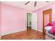 Bedroom with hardwood floors, pink walls, and a light at 1033 Rollingwood Dr, Charlotte, NC 28217