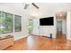 Inviting living room boasts original hardwood floors, large windows, and is bathed in natural light, perfect for relaxing at 1033 Rollingwood Dr, Charlotte, NC 28217