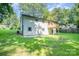 A view of the home's backyard featuring a wooden deck, lush green grass, and the home's exterior at 1048 Shenandoah Dr, Gastonia, NC 28052