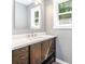 Bathroom featuring wood vanity with a white countertop, brushed nickel faucet, and accent mirror at 1048 Shenandoah Dr, Gastonia, NC 28052