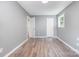 Bright bedroom featuring light gray walls, light wood-look floors, and a window at 1048 Shenandoah Dr, Gastonia, NC 28052