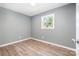 Bright bedroom featuring one window, light gray walls, and light wood-look flooring at 1048 Shenandoah Dr, Gastonia, NC 28052