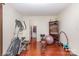 Home gym boasts hardwood floors, workout equipment, and natural light at 12822 Plumleaf Dr, Charlotte, NC 28213