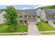 Aerial view of a two-story home with two-car garage, well-kept lawn and landscaping at 12822 Plumleaf Dr, Charlotte, NC 28213