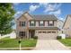 Charming two-story home with a two-car garage, stone accents, and manicured lawn at 12822 Plumleaf Dr, Charlotte, NC 28213