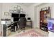 Spacious office with dark wood furniture, multiple monitors, and an area rug at 12822 Plumleaf Dr, Charlotte, NC 28213